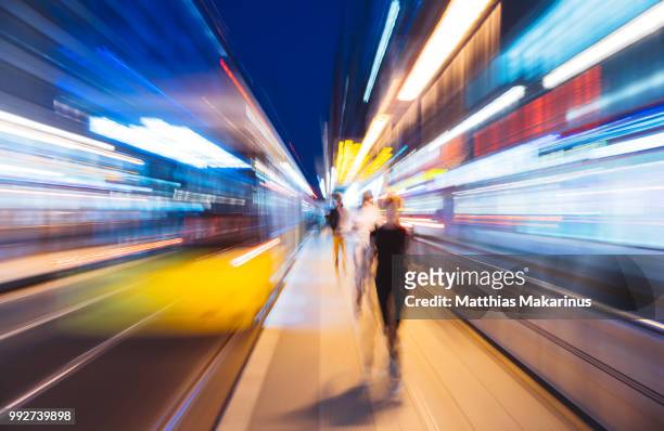 modern creative zoom rush hour night street szene in berlin with traffic lights - long exposure train stock pictures, royalty-free photos & images