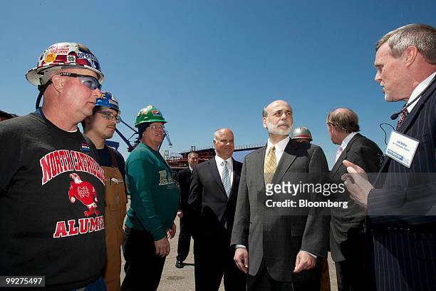 Ben S. Bernanke, chairman of the U.S. Federal Reserve, third from right, speaks with Jim Miller, president and chief executive officer of the Aker...