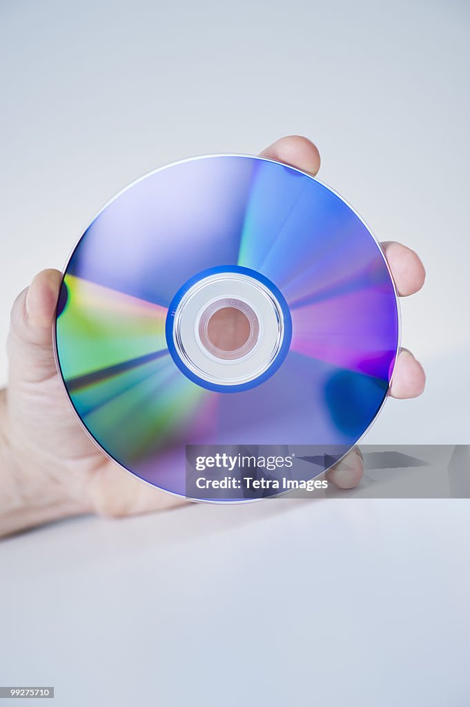 Hand holding compact disc