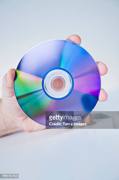 hand holding compact disc - cd ストックフォトと画像