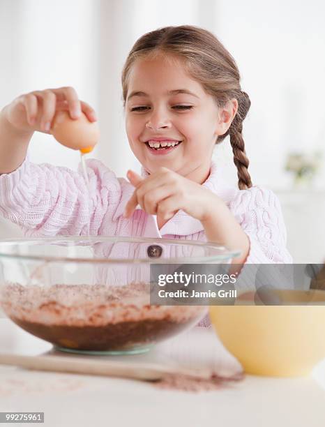 young girl cracking egg - crack spoon stock pictures, royalty-free photos & images