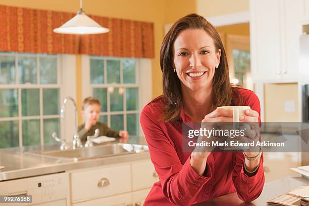 woman in kitchen - mark atkinson stock pictures, royalty-free photos & images