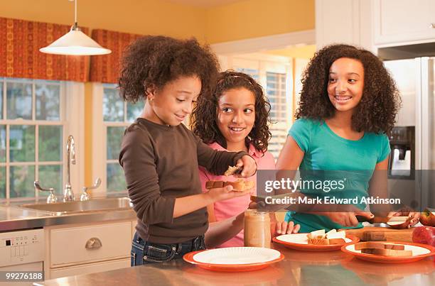 making peanut butter sandwiches - peanut butter and jelly sandwich on plate stock pictures, royalty-free photos & images