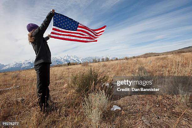 hiker holding american flag - dan peak stock pictures, royalty-free photos & images