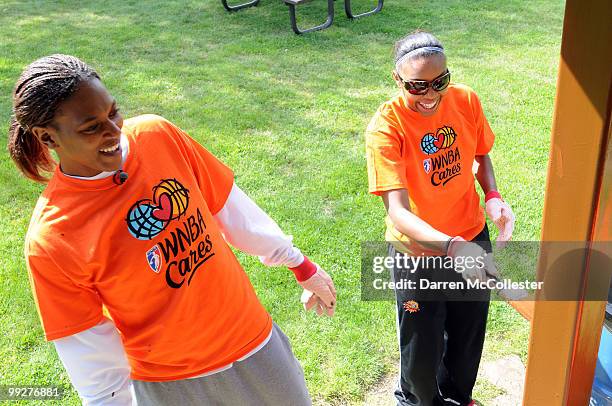 Asjha Jones and Renee Montgomery of the Connecticut Sun help paint a gazebo during a beautification day at Waterford Beach Park May 13, 2010 in...
