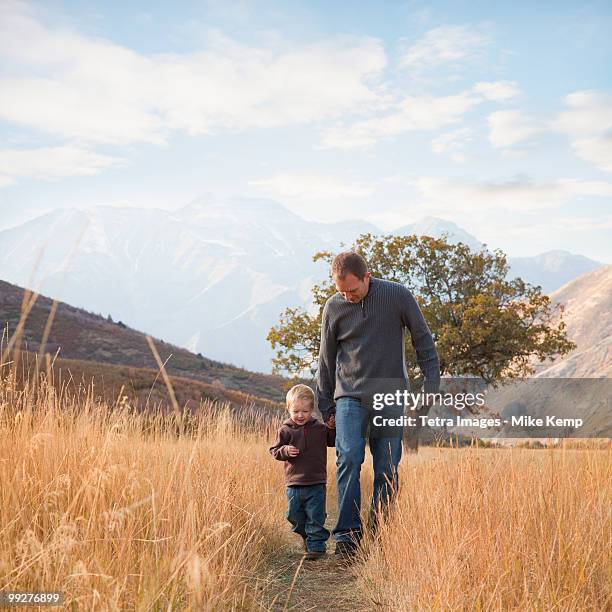 father and son walking outdoors - wasatch mountains stock pictures, royalty-free photos & images