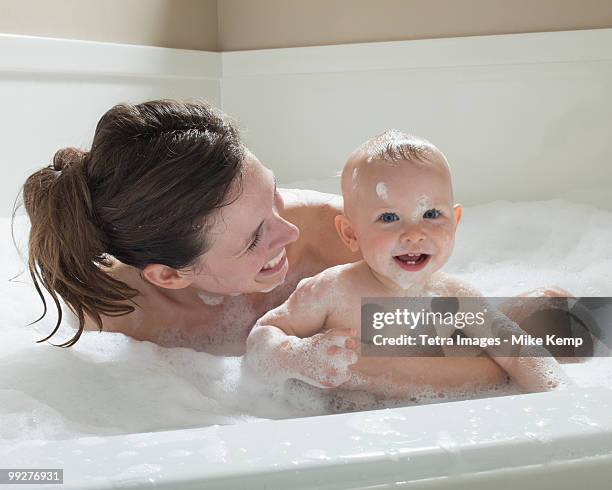 mother and baby having bubble bath - mother and baby taking a bath stock pictures, royalty-free photos & images