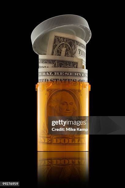 money in prescription bottle - health savings account stockfoto's en -beelden