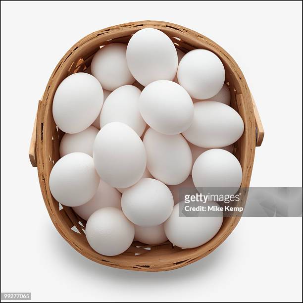 basket of eggs - eggs in basket stock pictures, royalty-free photos & images