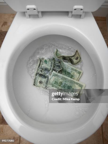 money down the toilet - money down the drain stock pictures, royalty-free photos & images