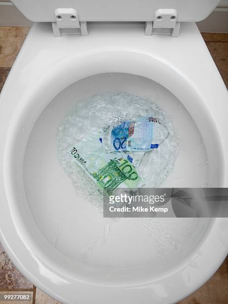 money down the toilet - losing money stock pictures, royalty-free photos & images