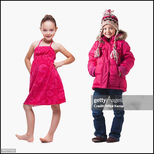 identical twins - girl in winter coat studio stock pictures, royalty-free photos & images