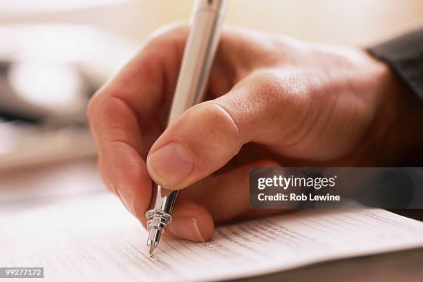 man writing with a pen - personalizzazione foto e immagini stock