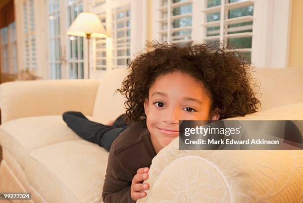 young girl on couch - mark atkinson stock pictures, royalty-free photos & images