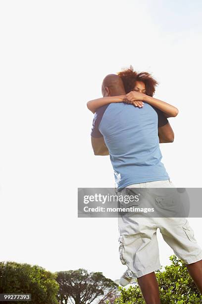 couple embracing - hedge fonds stock pictures, royalty-free photos & images