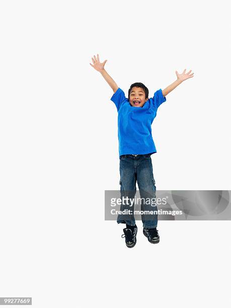 boy jumping - kid hand raised stock pictures, royalty-free photos & images