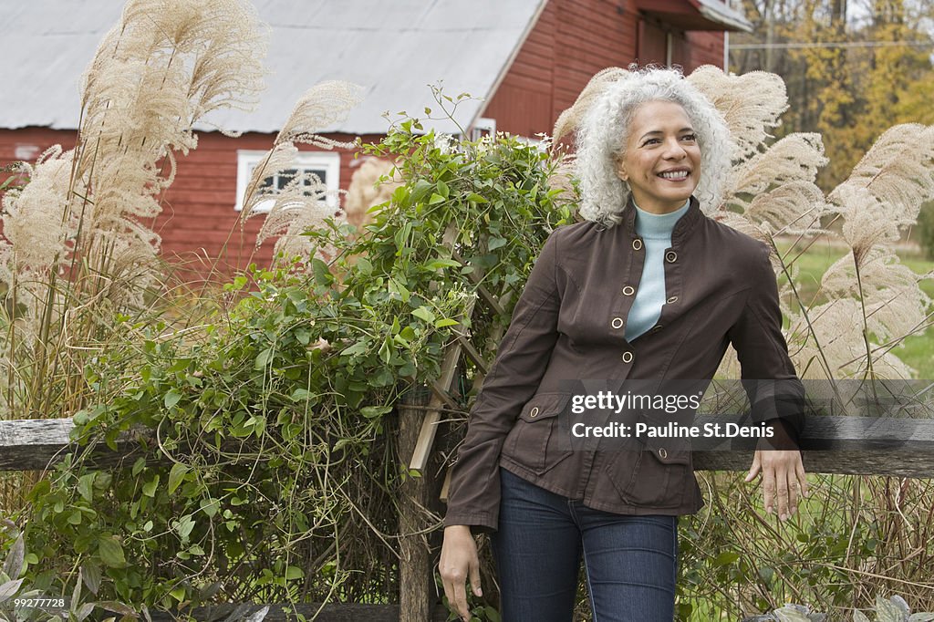 Woman leaning against fence