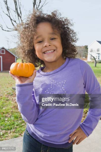 young girl holding pumpkin - new paltz stock pictures, royalty-free photos & images