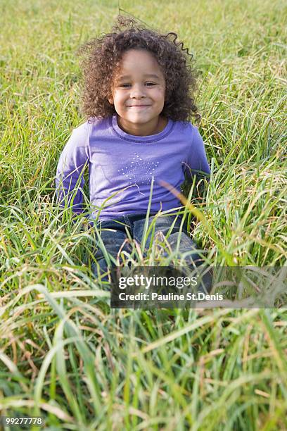 young girl sitting in tall grass - ulster county stock pictures, royalty-free photos & images