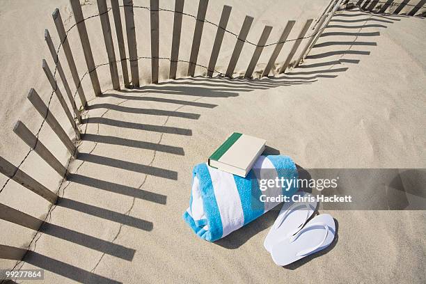 fence on the beach - striped towel stock pictures, royalty-free photos & images