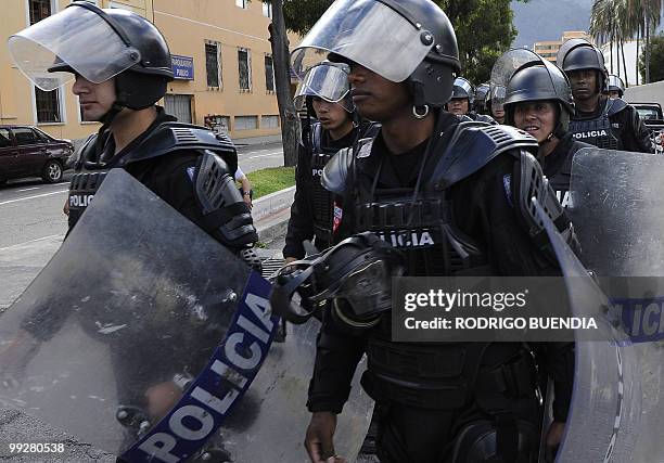 Ecuadorean riot policemen stand guard near the National Assembly headquarters where an indigenous group demonstrate against a proposed water...