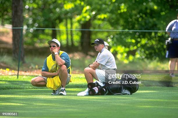 Women's Open: Emilee Klein sitting on her bag of clubs and waiting with her caddie during five hour long first round on Thursday at Pine Needles...