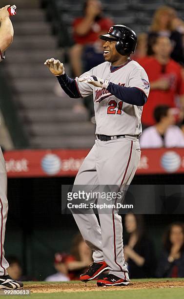 Delmon Young of the Minnesota Twins celebrates as he scores on his three run home run in the ninth inning against the Los Angeles Angels of Anaheim...