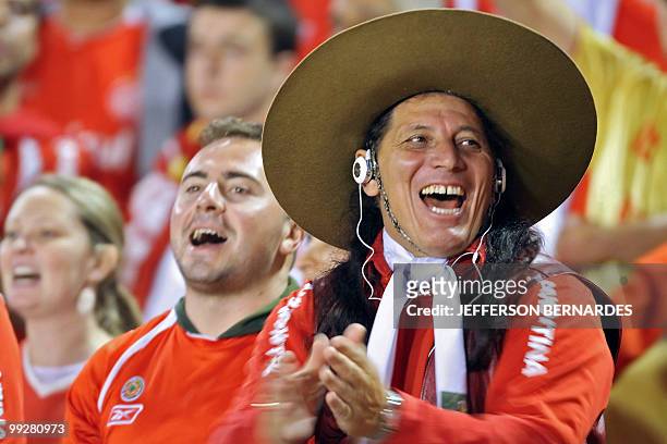 Brazilian Internacional's supporters cheer their team before the start of their Libertadores Cup football match against Argentinian Estudiantes at...