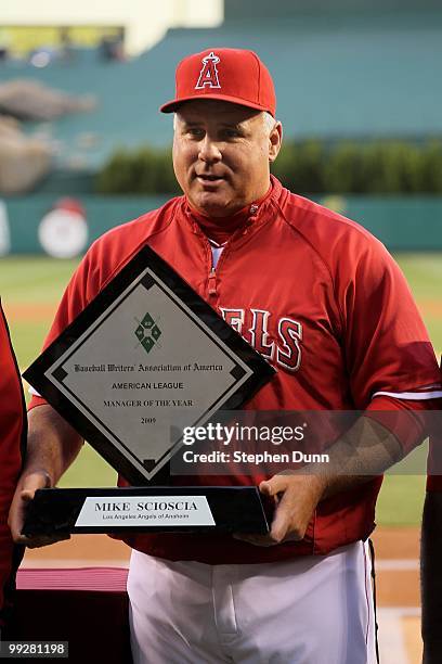 Manager Mike Scioscia of the Los Angeles Angels of Anaheim receives his 2009 American League Manager of the Year award before the game with the...