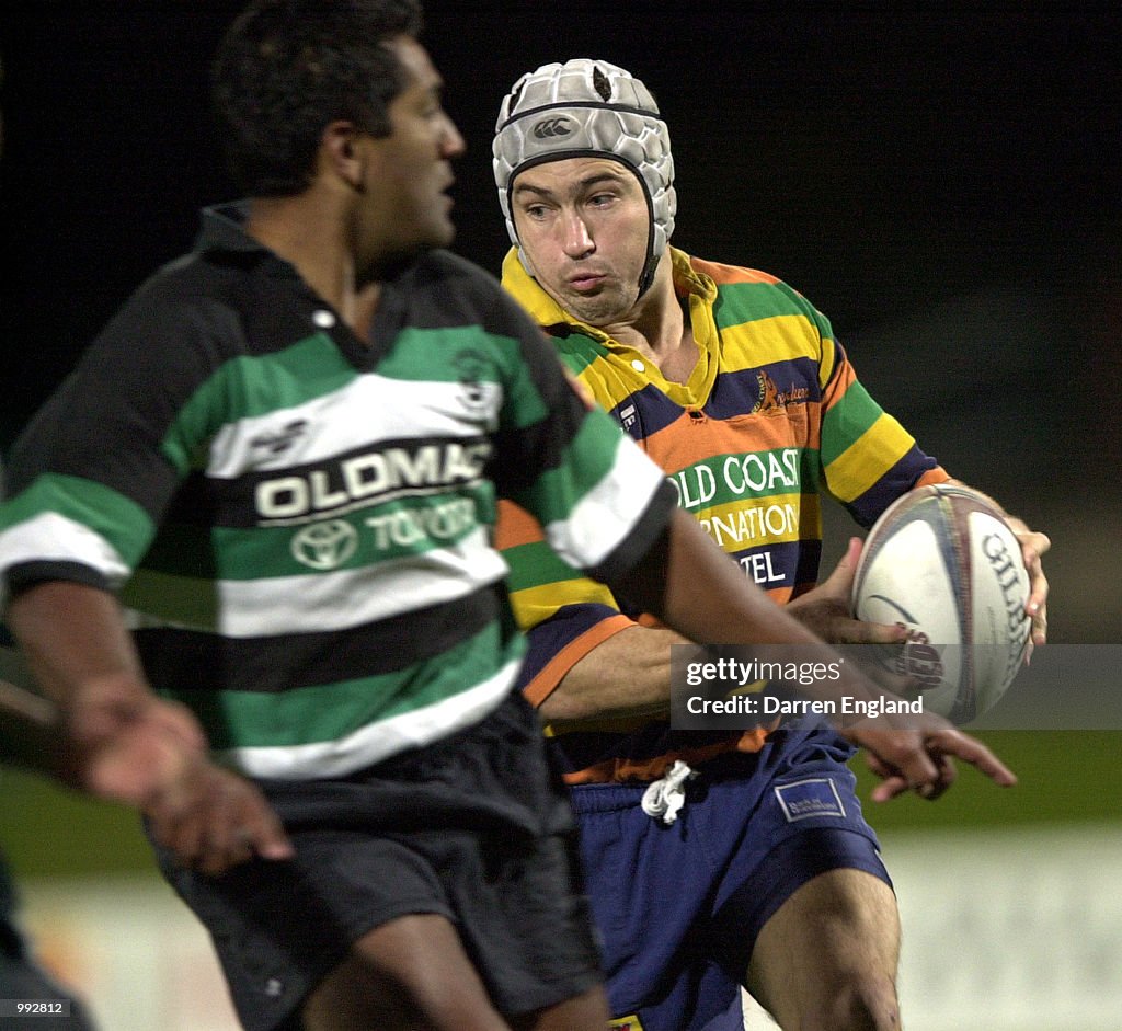 Jason Ramsamy Jeremy Austin of the Gold Coast gets past the tackle of Jason Ramsamy ...