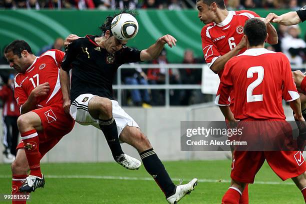 Serdar Tasci of Germany is challenged by Kenneth Scicluna and Ryan Fenech of Malta during the international friendly match between Germany and Malta...