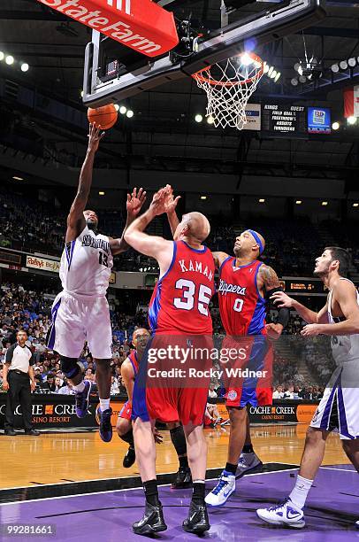 Tyreke Evans of the Sacramento Kings shoots a layup against Chris Kaman and Drew Gooden of the Los Angeles Clippers during the game at Arco Arena on...