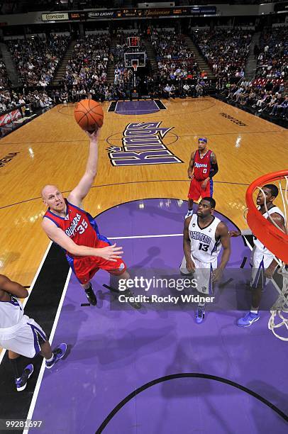 Chris Kaman of the Los Angeles Clippers goes up for a shot against Tyreke Evans of the Sacramento Kings during the game at Arco Arena on April 8,...