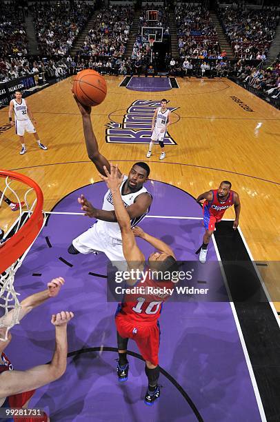 Tyreke Evans of the Sacramento Kings shoots a layup against Eric Gordon of the Los Angeles Clippers during the game at Arco Arena on April 8, 2010 in...