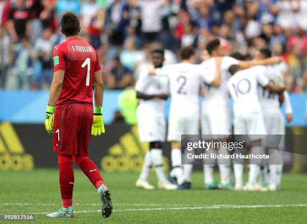 Fernando Muslera of Uruguay looks dejected as Antoine Griezmann of France celebrates with teammates after scoring his team's second goal during the...