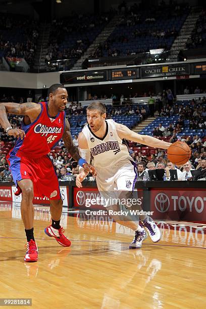 Andres Nocioni of the Sacramento Kings drives the ball against Rasual Butler of the Los Angeles Clippers during the game at Arco Arena on April 8,...