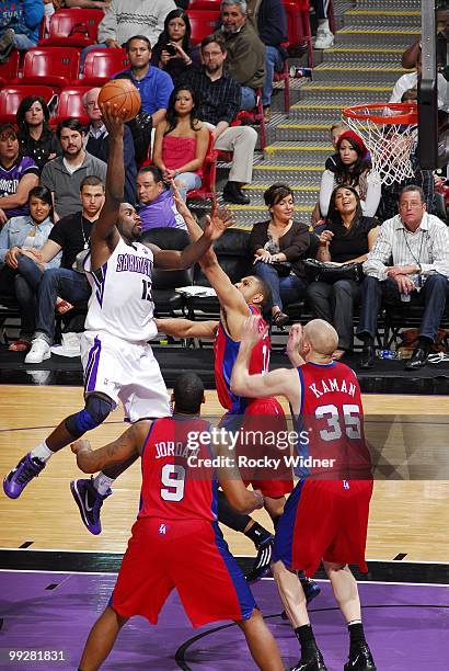 Tyreke Evans of the Sacramento Kings goes up for a shot against Chris Kaman, DeAndre Jordan and Eric Gordon of the Los Angeles Clippers during the...