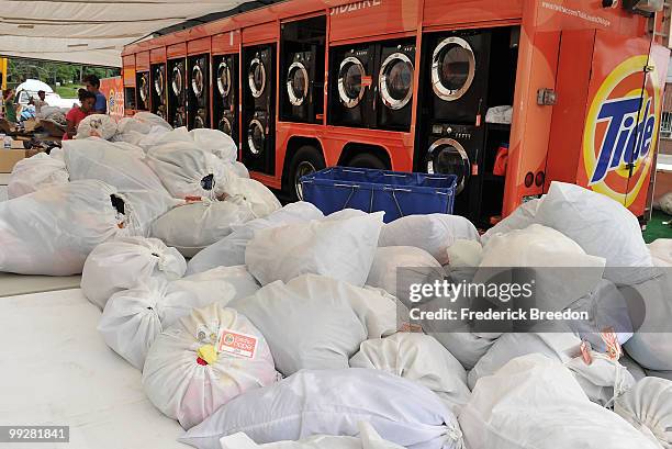 Hundreds of loads of laundry line the ground at Tide's Loads Of Hope mobile laundry program at Loads of Hope Truck - Laundry Drop-Off Site: Dollar...