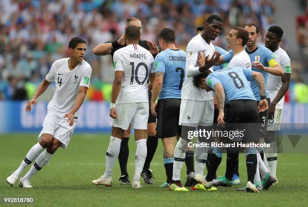 Uruguay and France players clash during the 2018 FIFA World Cup Russia Quarter Final match between Uruguay and France at Nizhny Novgorod Stadium on...