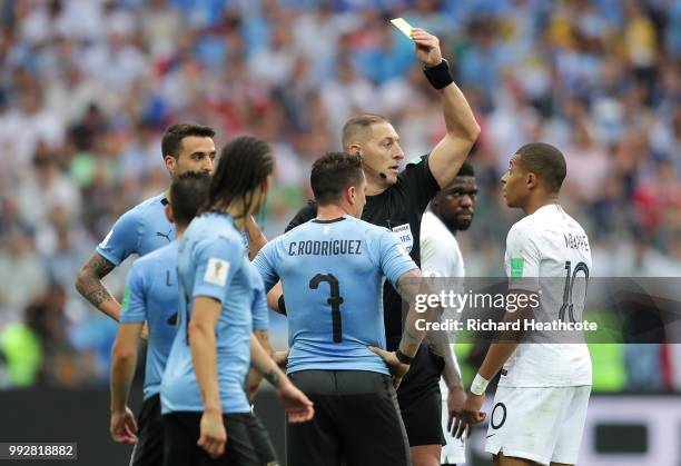 Kylian Mbappe of France is shown a yellow card by referee Nestor Pitana during the 2018 FIFA World Cup Russia Quarter Final match between Uruguay and...