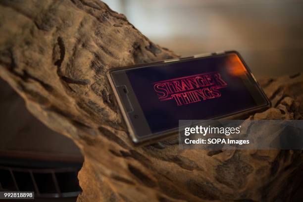 In this photo illustration, the logo 'Stranger Things' from the Netflix TV serie seen displayed on a Sony smartphone.