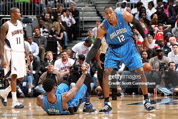 Dwight Howard helps up teammate Mickael Pietrus of the Orlando Magic against the Atlanta Hawks in Game Four of the Eastern Conference Semifinals...