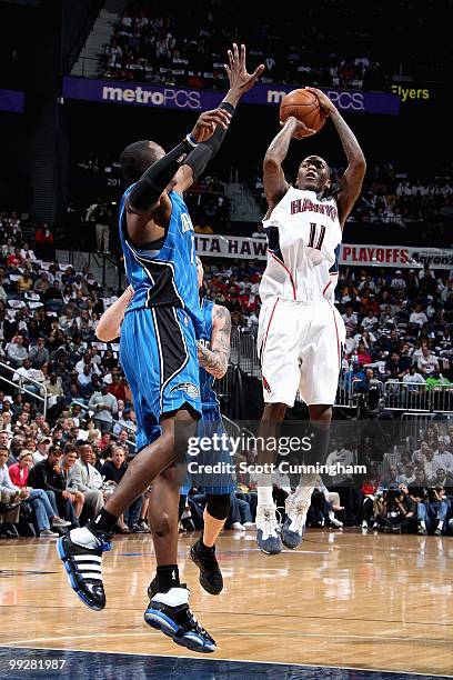 Jamal Crawford of the Atlanta Hawks shoots over Dwight Howard of the Orlando Magic in Game Four of th Eastern Conference Semifinals during the 2010...