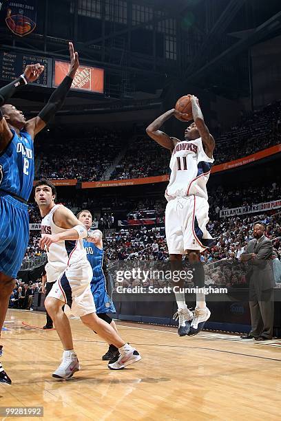 Jamal Crawford of the Atlanta Hawks shoots over Dwight Howard of the Orlando Magic in Game Four of th Eastern Conference Semifinals during the 2010...
