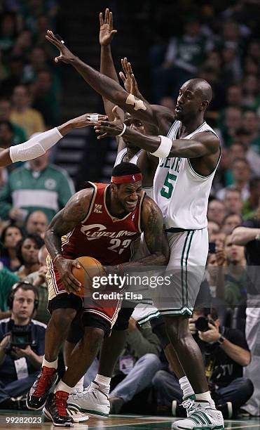 Kevin Garnett and Kendrick Perkins of the Boston Celtics keep LeBron James of the Cleveland Cavaliers from the basket in the first half during Game...