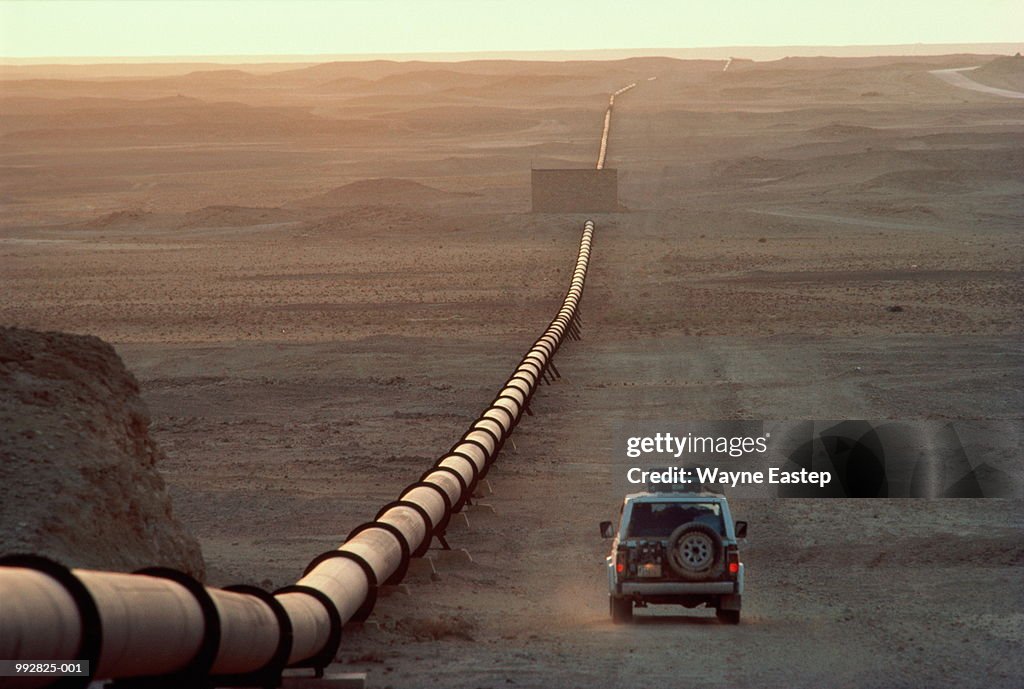 Saudi Arabia, main oil pipeline, car driving by at dusk