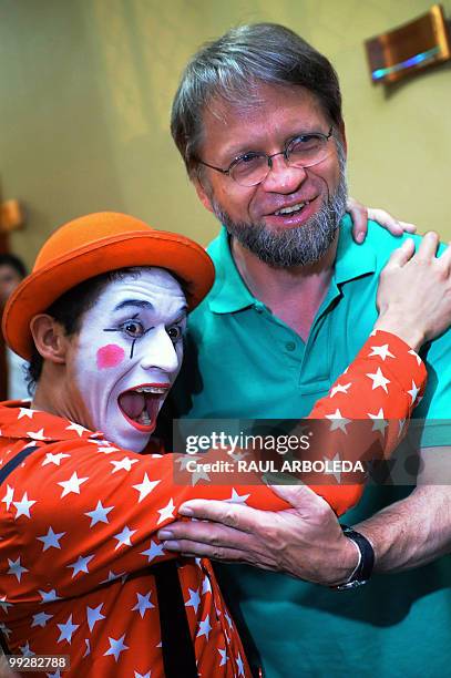 Colombian presidential candidate for the Green Party, Antanas Mockus, is greeted by a clown during a women rally in Medellin, Antioquia department,...