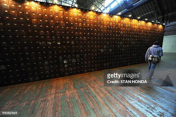 Foot wall of stacked oxidized biscuit tins that is part of French artist Christain Boltanski's "No Man's Land", composed of 30 tons of discarded...