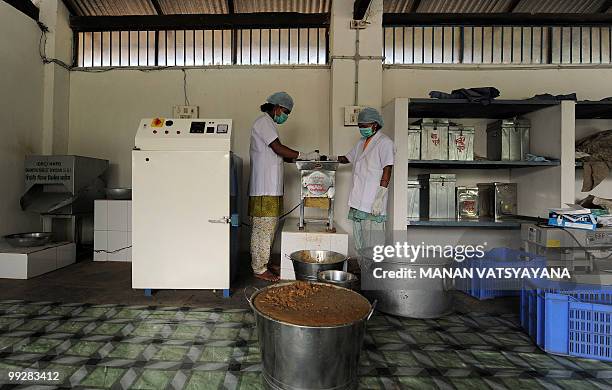 India-Maoist-unrest-forests-economy,FEATURE by Pratap Chakravarty Indian women work at a state-run processing facility in the village of Dugli, some...