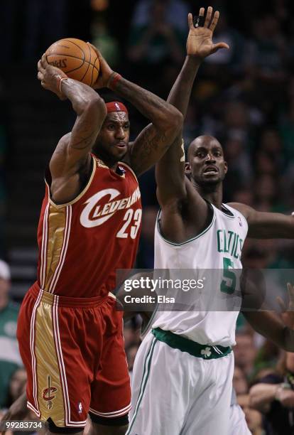 LeBron James of the Cleveland Cavaliers passes the ball as Kevin Garnett of the Boston Celtics defends during Game Six of the Eastern Conference...